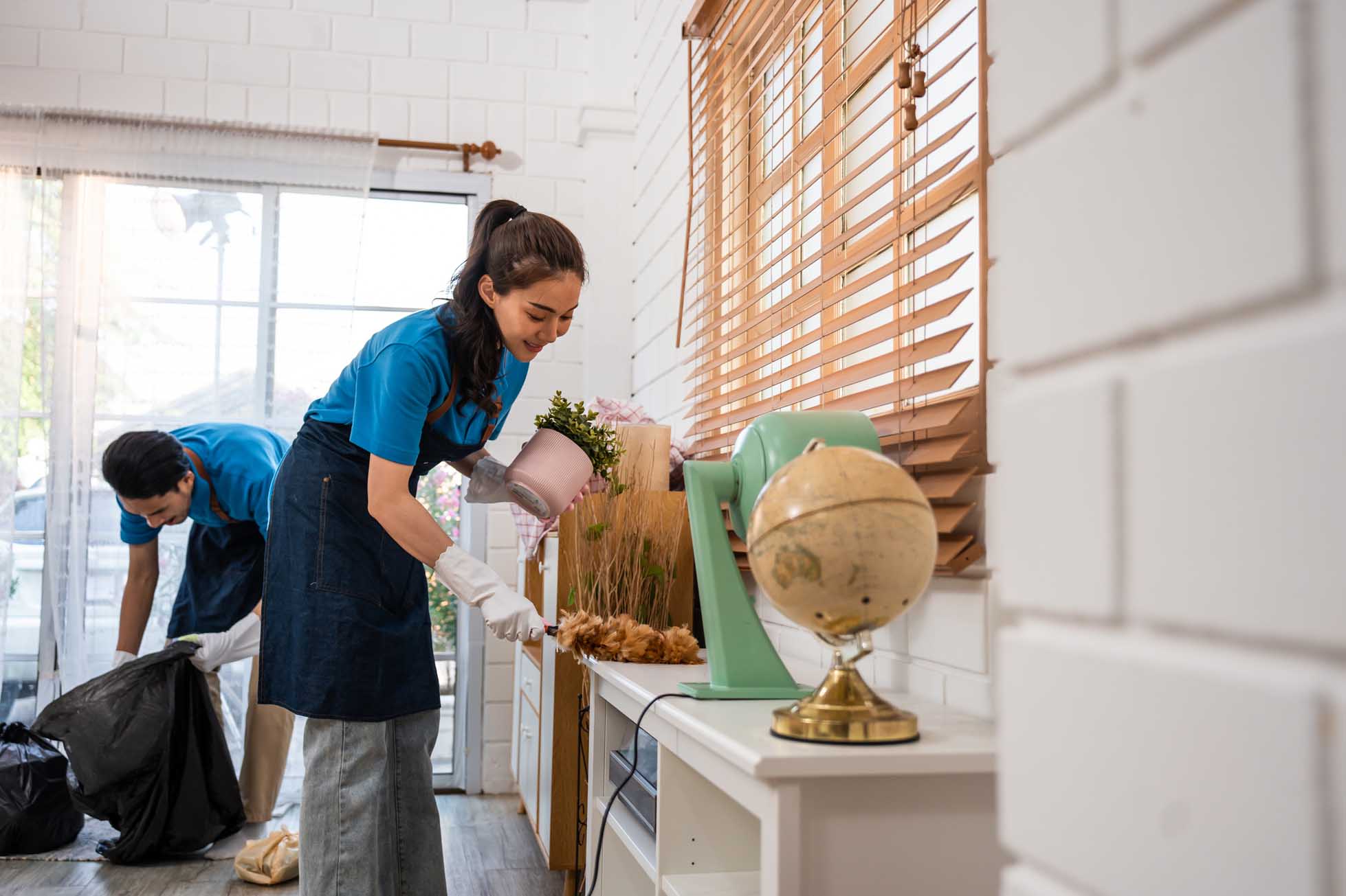 Asian young man and woman cleaning service worker work in living